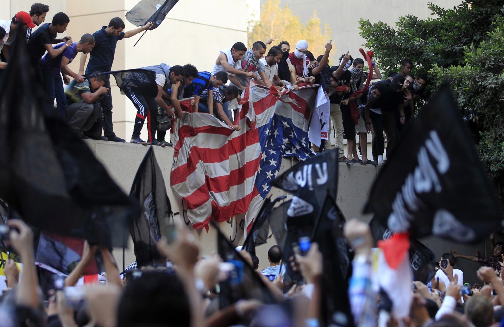 Protesters destroy an American flag pulled down from the U.S. embassy in Cairo September 11, 2012. Egyptian protesters scaled the walls of the U.S. embassy on Tuesday, tore down the American flag and burned it during a protest over what they said was a film being produced in the United States that insulted Prophet Mohammad. REUTERS/Mohamed Abd El Ghany (caption credit: Reuters)