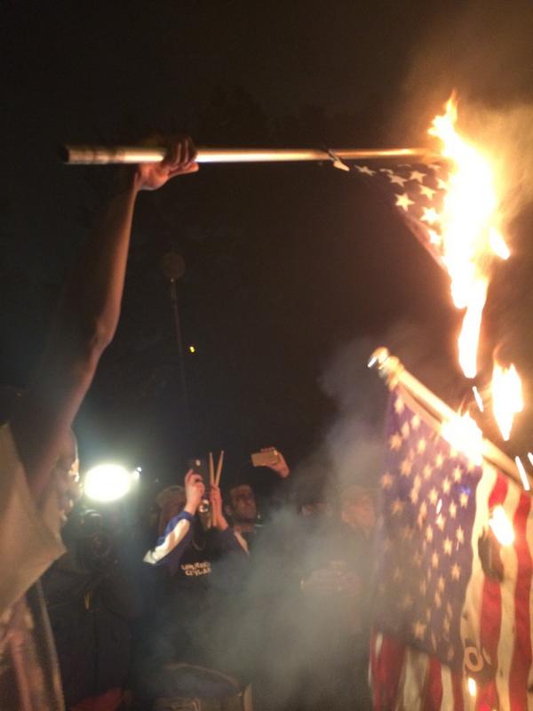 U.S. protesters burn American flag after #shawshooting in St Louis.